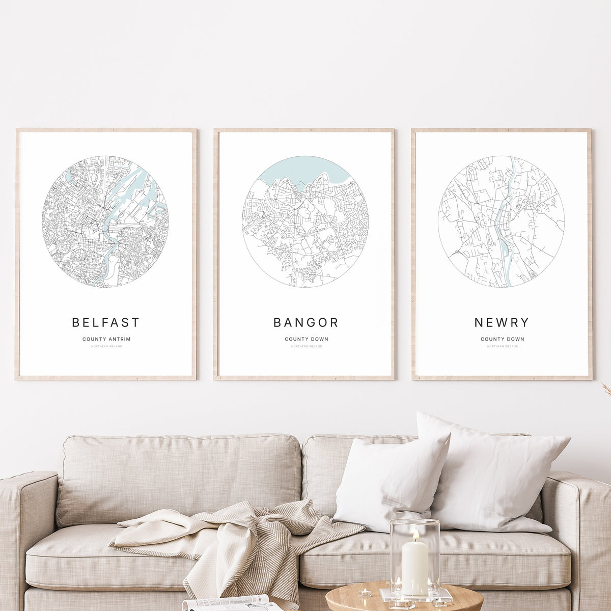 Trio of Belfast, Bangor and Newry city map prints in a living room.