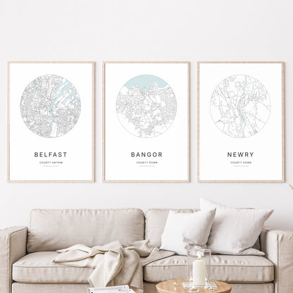 Trio of Belfast, Bangor and Newry city map prints in a living room.