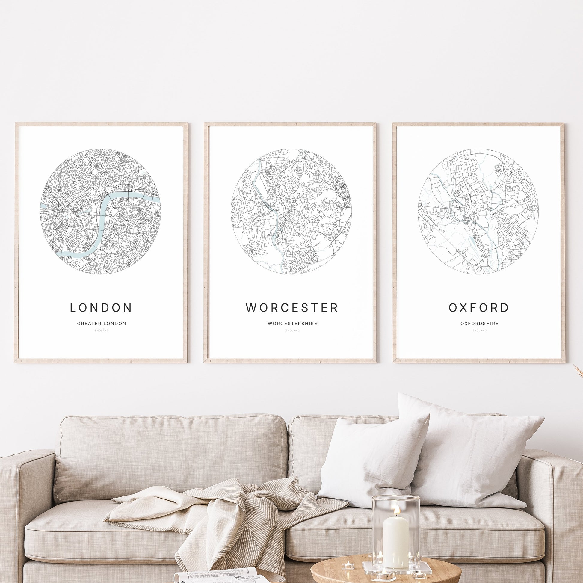 Trio of Birmingham, Worcester and Oxford city map prints in a living room.