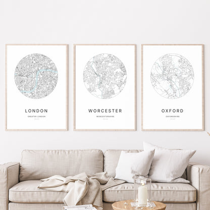 Trio of Birmingham, Worcester and Oxford city map prints in a living room.