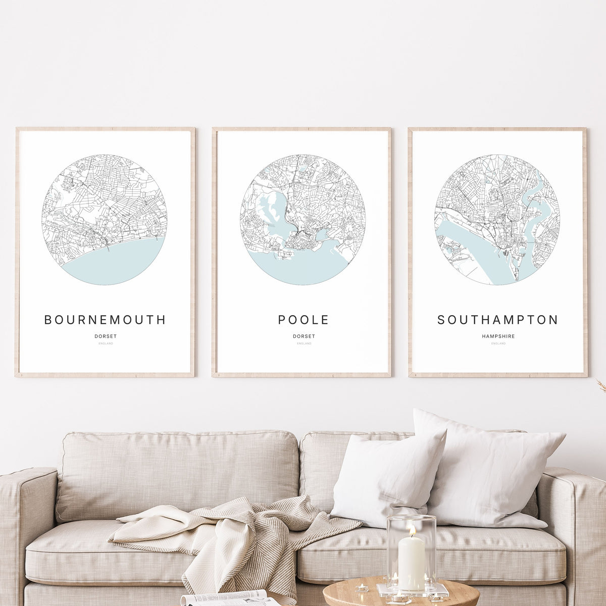Trio of Bournemouth, Poole and Southampton city map prints in a living room.