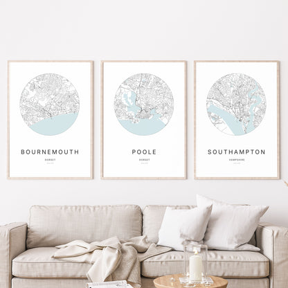 Trio of Bournemouth, Poole and Southampton city map prints in a living room.