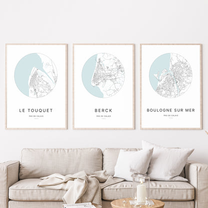 Composition murale de trois affiches minimalistes de villes (Berck, Le Touquet-Paris-Plage, Boulogne-sur-Mer) encadrées au-dessus d’un canapé dans un salon moderne.