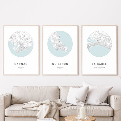 Composition murale de trois affiches minimalistes de villes (Quiberon, Carnac, La Baule) encadrées au-dessus d’un canapé dans un salon moderne.
