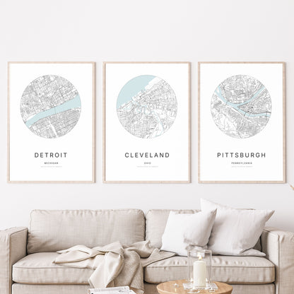 Trio of Detroit, Cleveland and Pittsburgh city map posters in a living room.