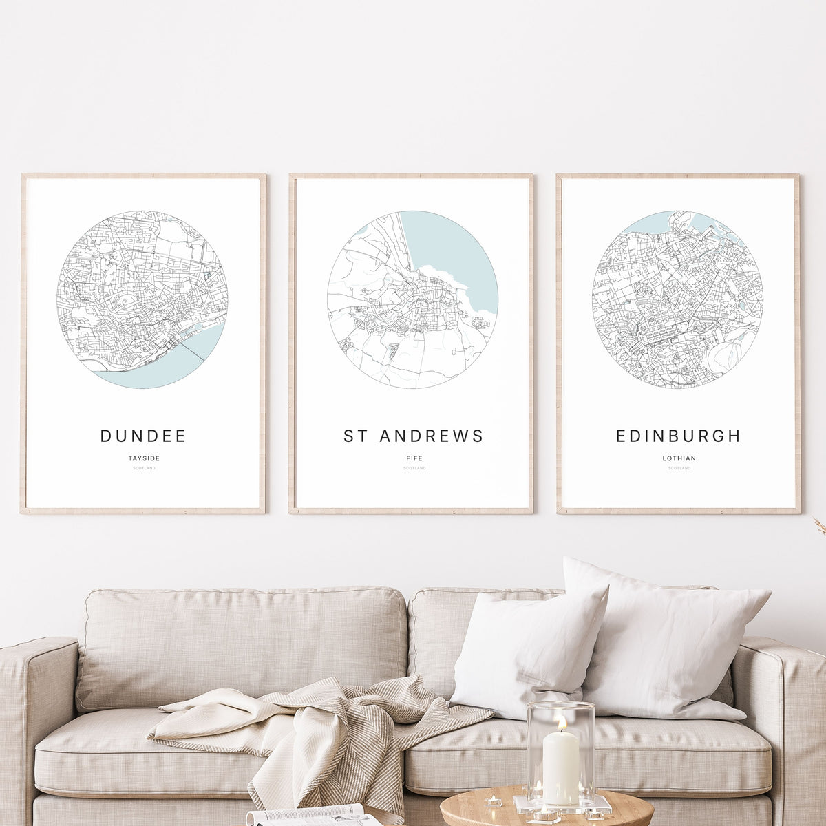 Trio of Dundee, St Andrews and Edinburgh city map prints in a living room.