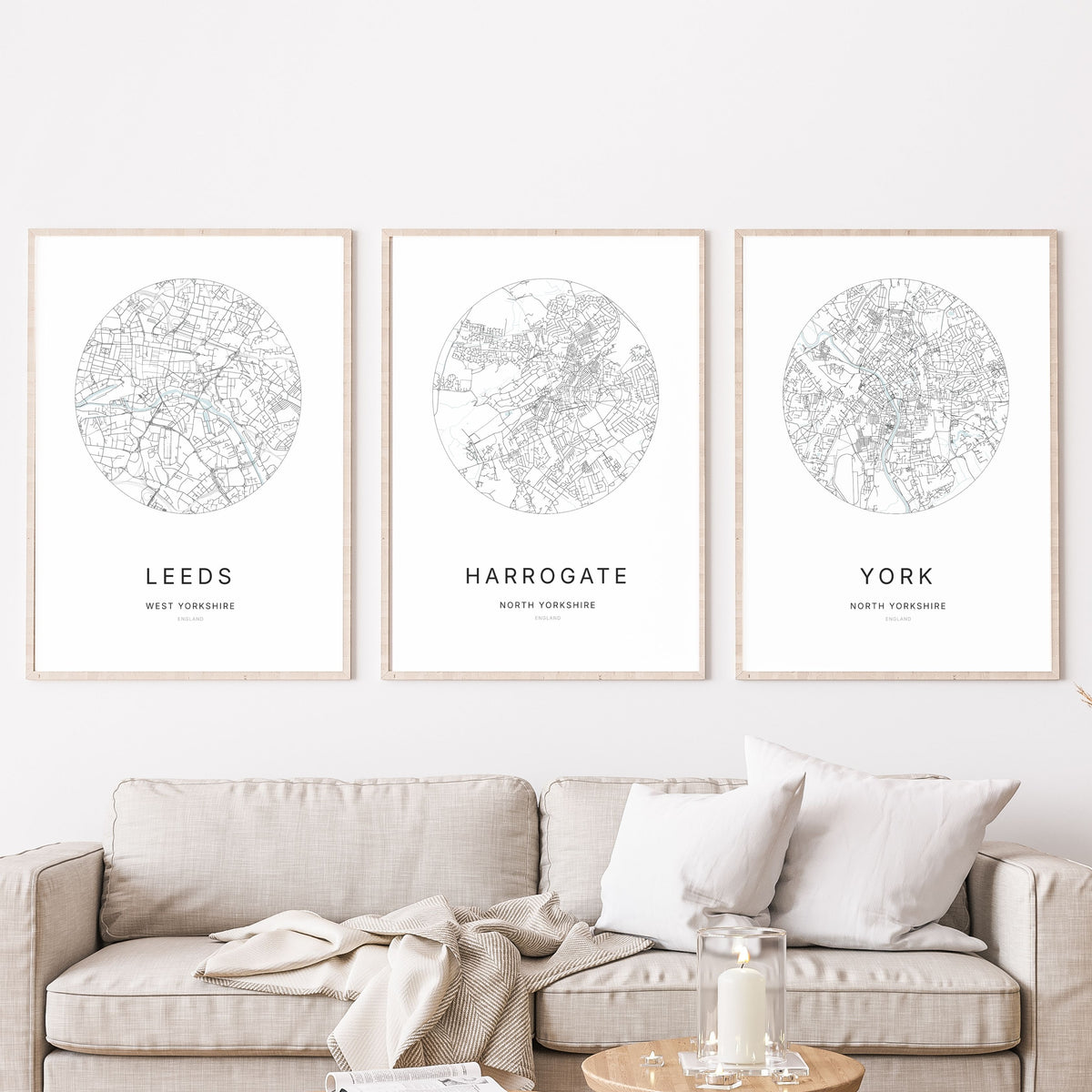 Trio of Leeds, Harrogate and York city map prints in a living room.