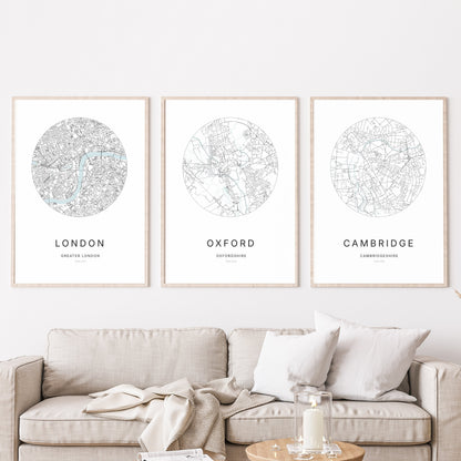 Trio of London, Oxford and Cambridge city map prints in a living room.