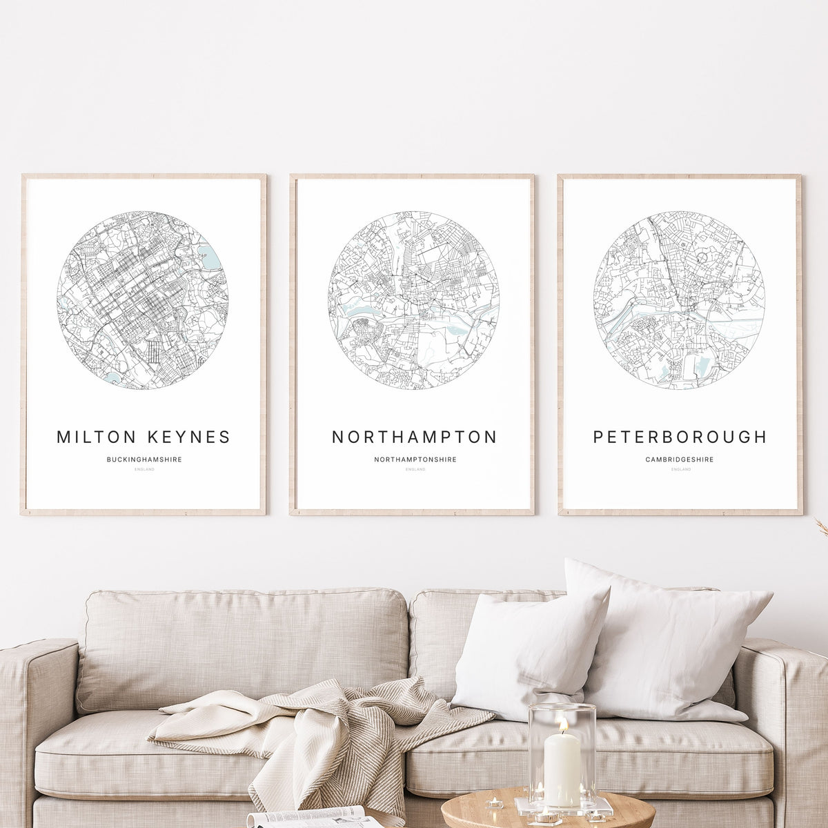 Trio of Milton Keynes, Northampton and Peterborough city map prints in a living room.