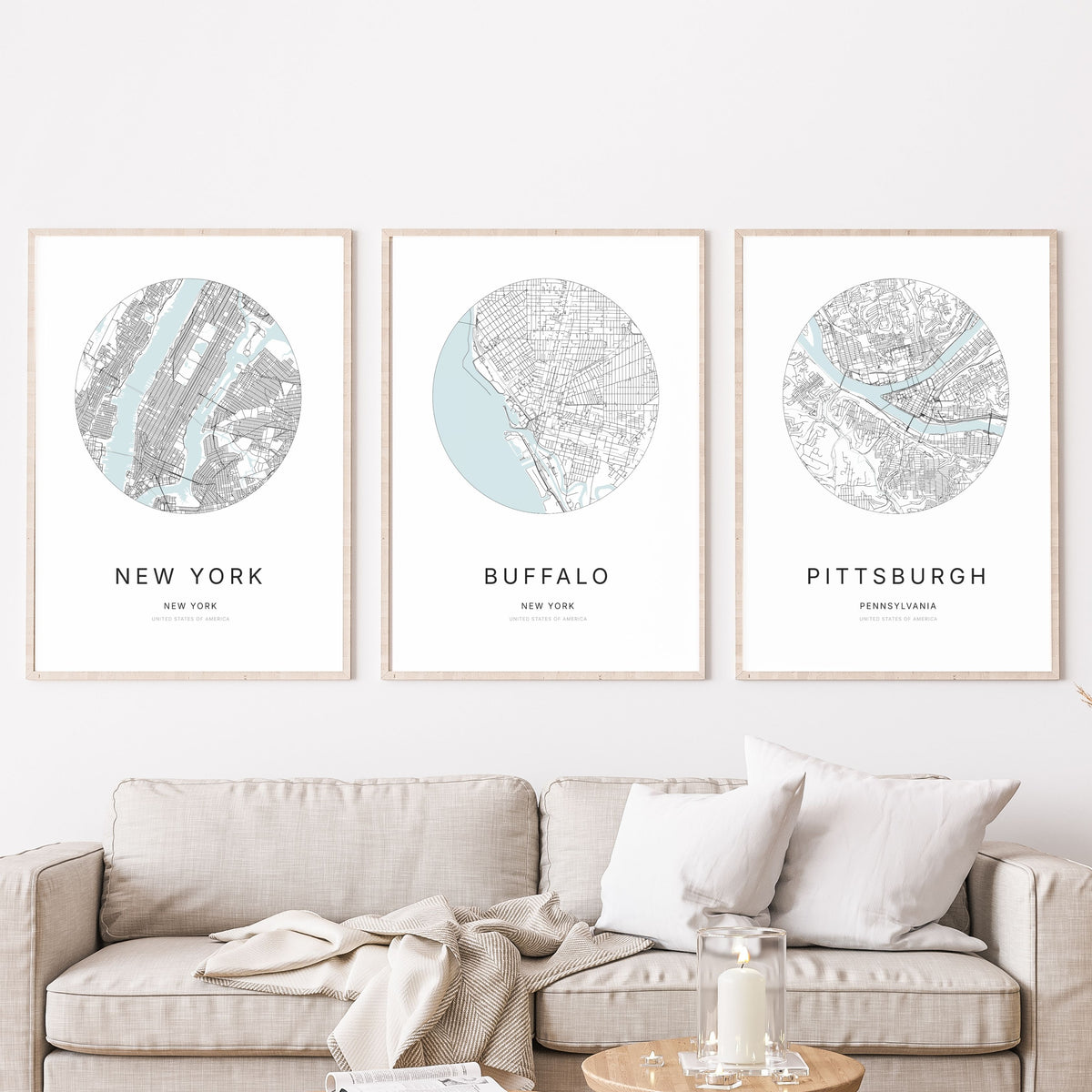 Trio of New York City, Buffalo and Pittsburgh city map posters in a living room.