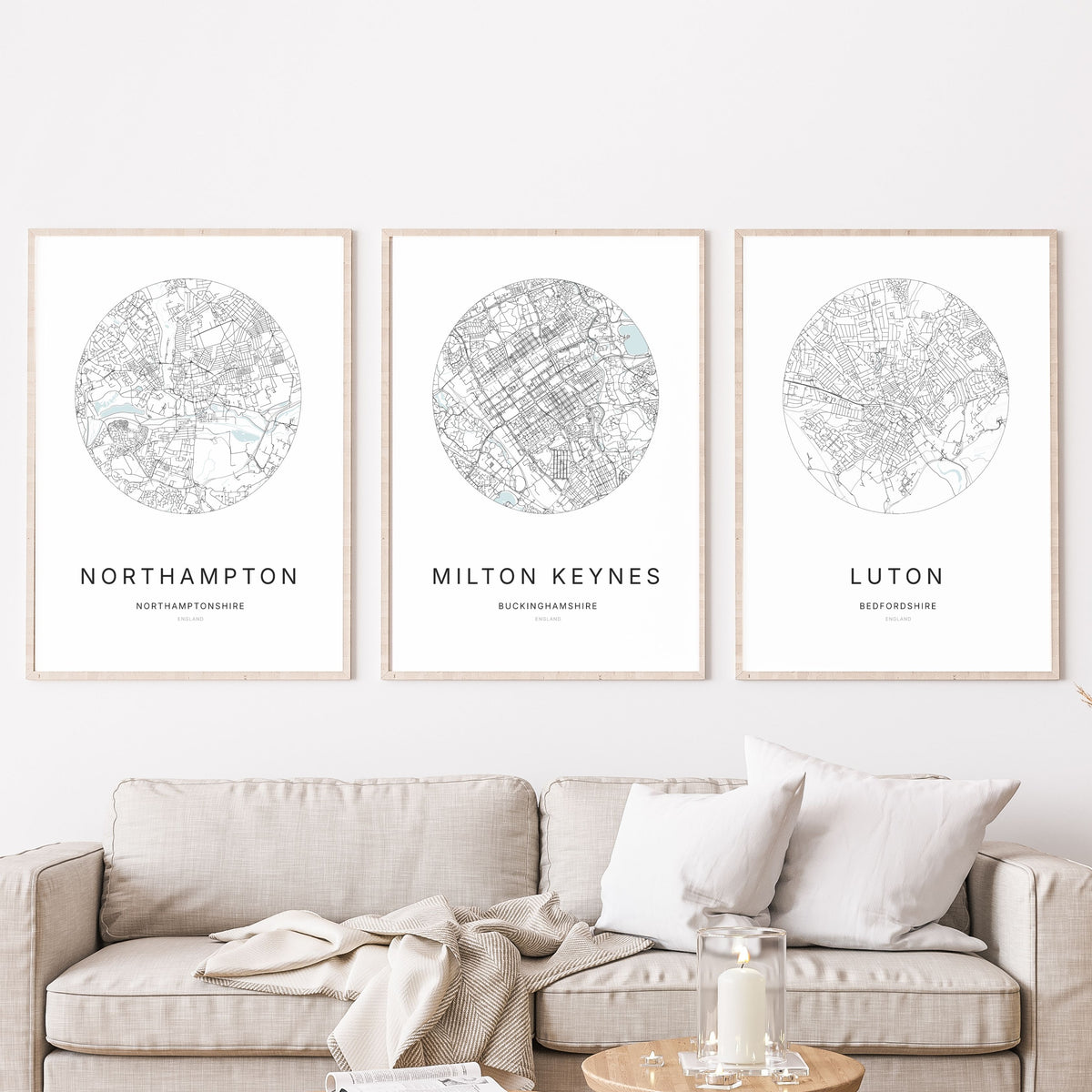 Trio of Northampton, Milton Keynes and Luton city map prints in a living room.