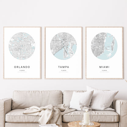 Trio of Orlando, Tampa and Miami city map posters in a living room.
