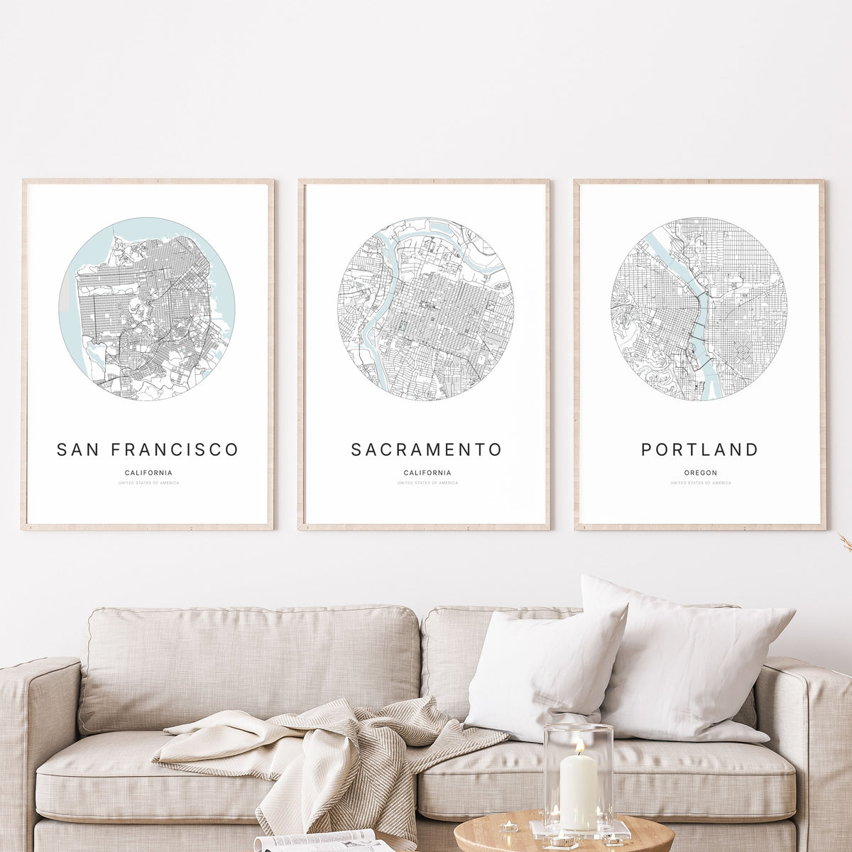 Trio of San Francisco, Sacramento and Portland city map posters in a living room.