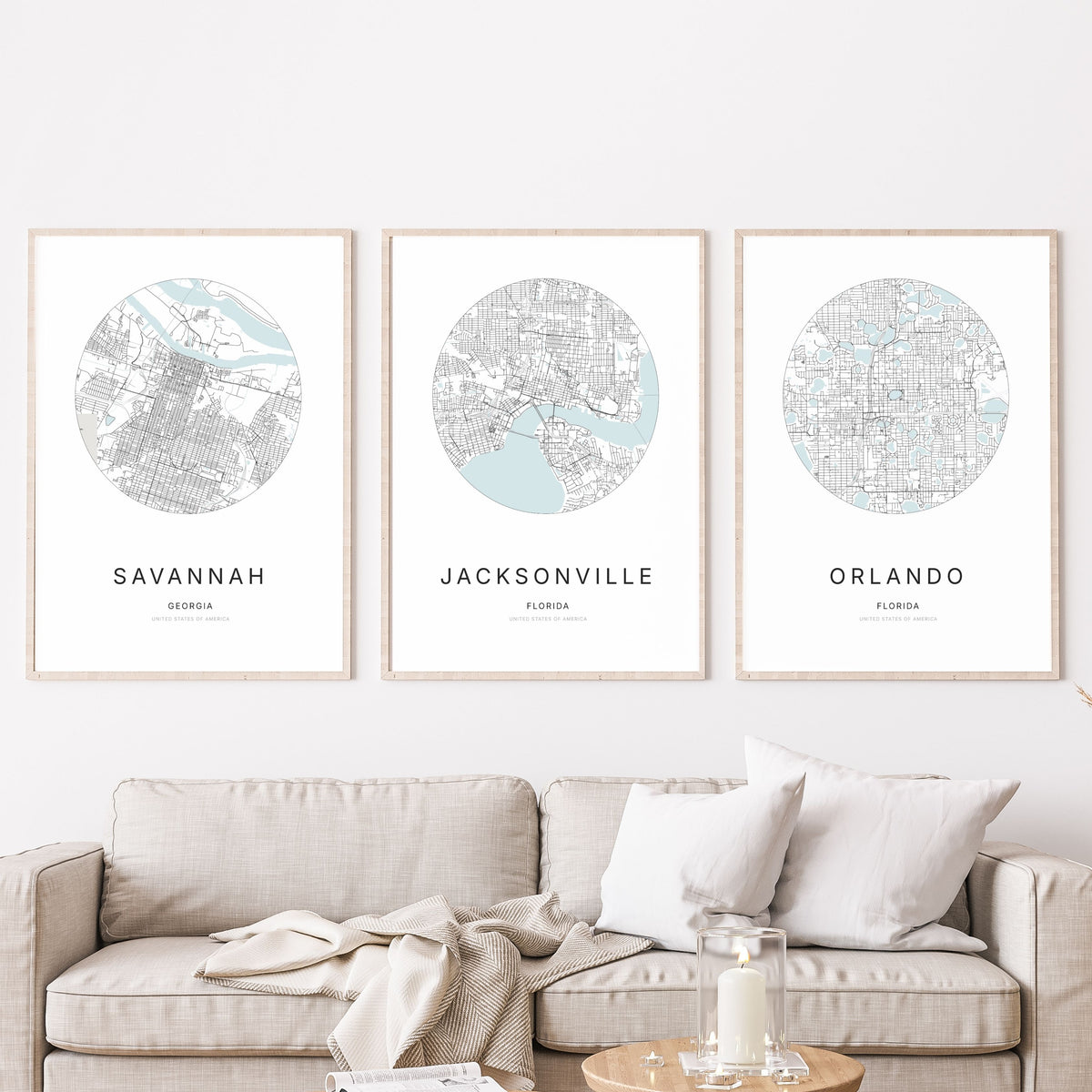 Trio of Savannah, Jacksonville and Orlando city map posters in a living room.