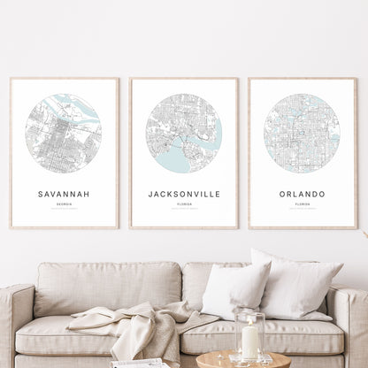 Trio of Savannah, Jacksonville and Orlando city map posters in a living room.
