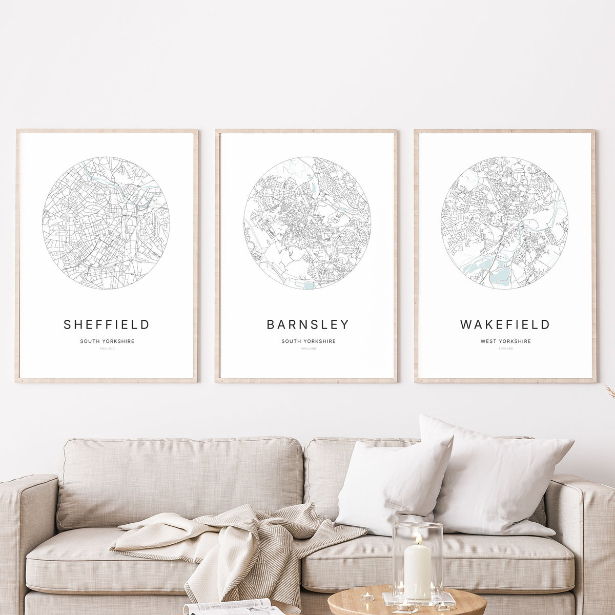 Trio of Sheffield, Barnsley and Wakefield city map prints in a living room.