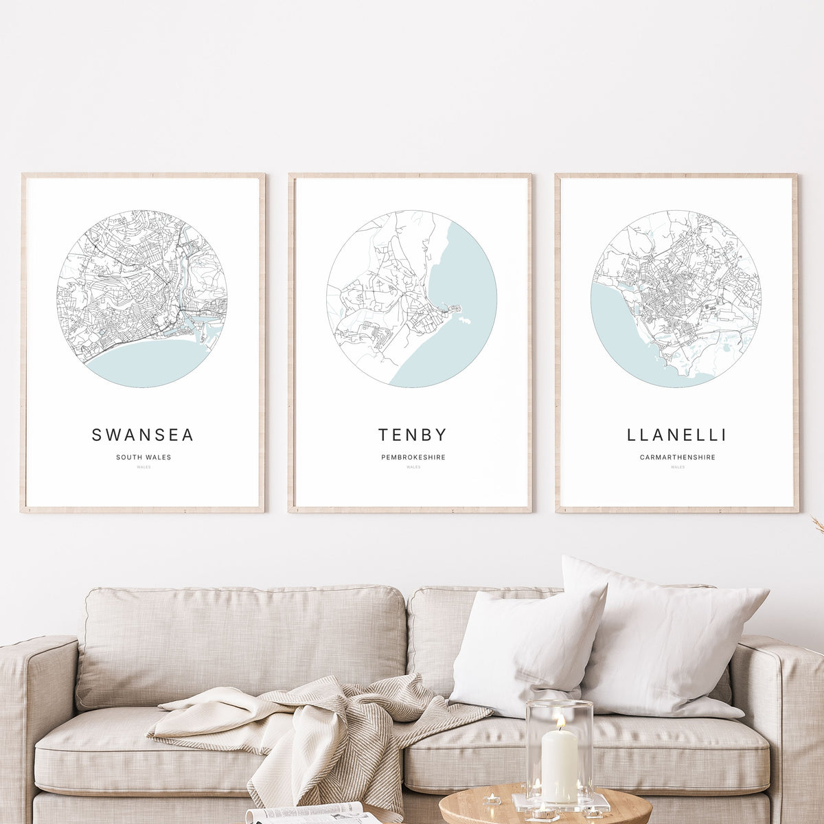 Trio of Swansea, Tenby and Llanelli city map prints in a living room.