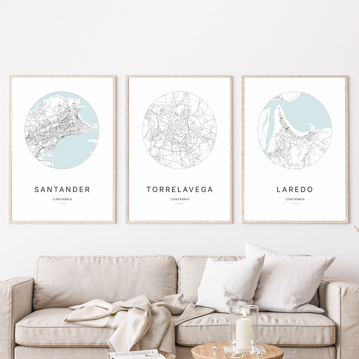 Trío de pósteres de Torrelavega, Santander y Laredo en un salón.